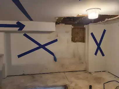 Wet ceiling opened and marked with tape for removal