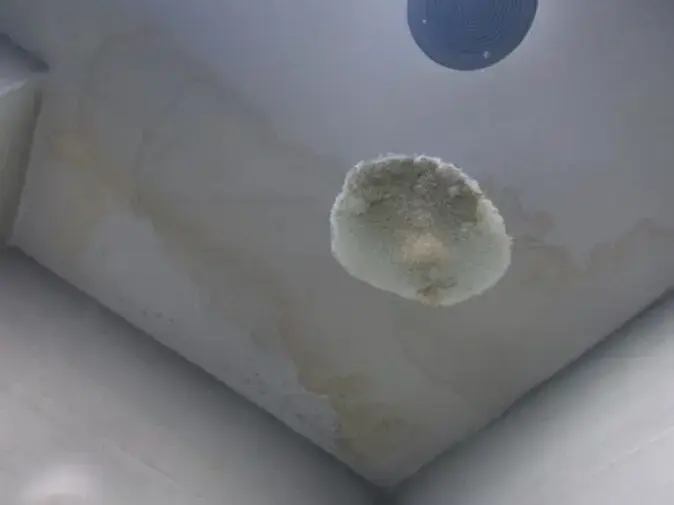 Stained and sagging ceiling from a bathroom leak above