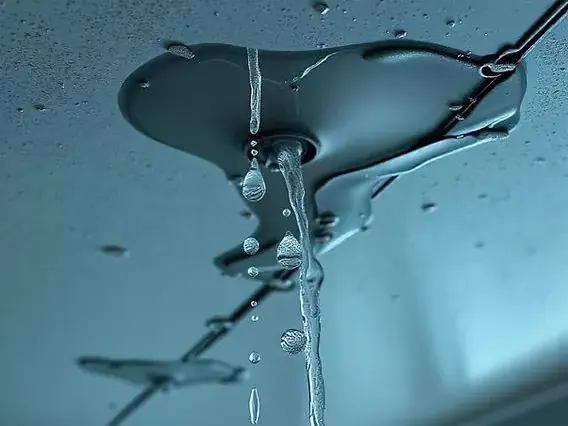 Rain water leaking through a ceiling during a winter storm