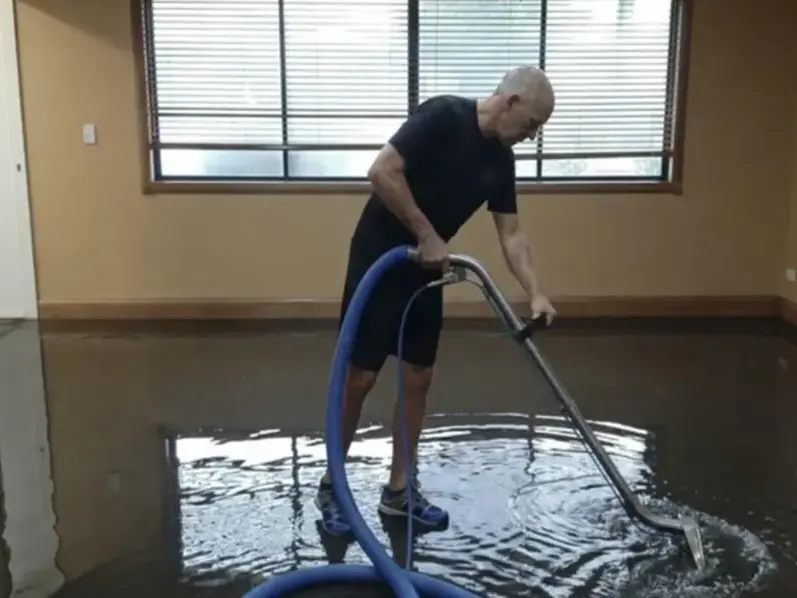 Extraction wand pulling standing water off a floor in a Santa Monica home